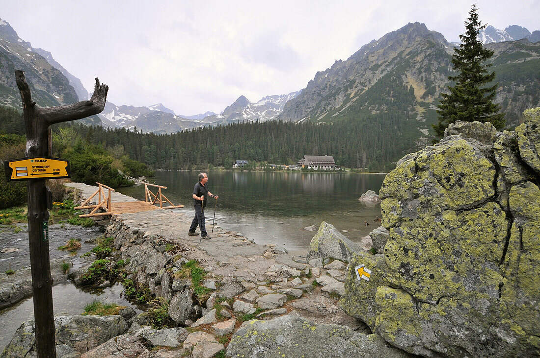 Hiker at lake Popradske with Rysy mountain, High Tatra, Slovakia, Europe