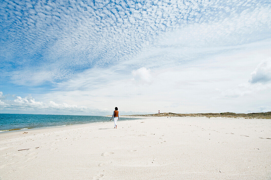 Woman walking barefooted on the beach, Island of Sylt, Schleswig Holstein, Germany, Europe