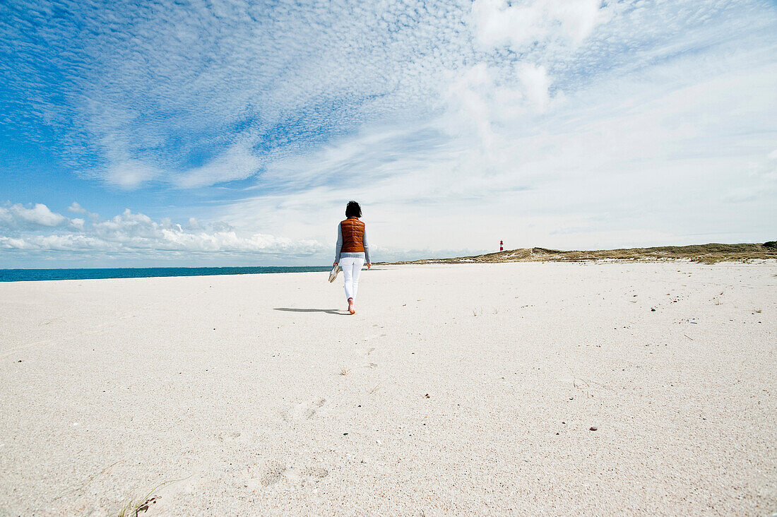 Woman walking barefooted on the beach, Island of Sylt, Schleswig Holstein, Germany, Europe