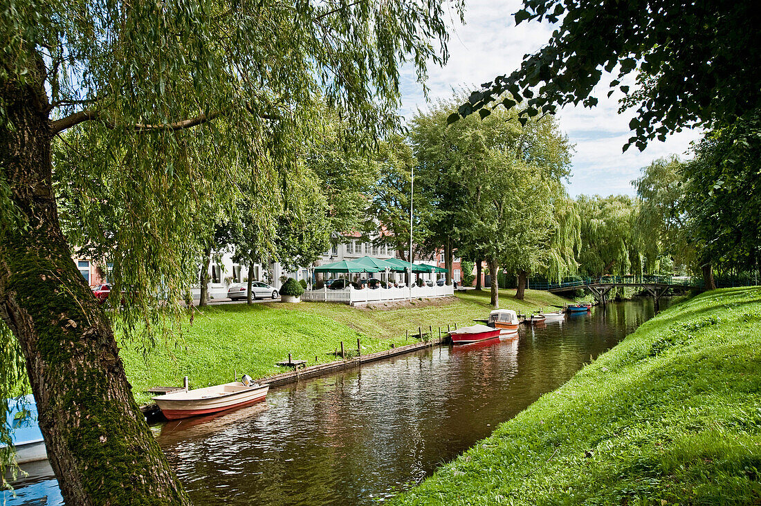 Canal with boats beneath trees, Friedrichstadt, Schleswig Holstein, Germany, Europe