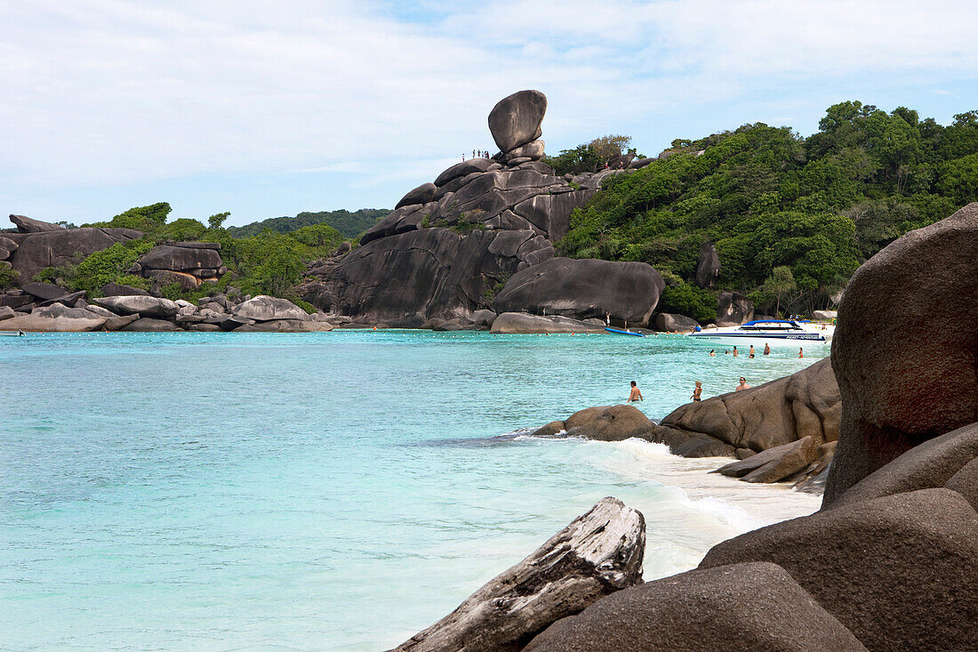 Tourists standing on top of Sail Rock and on sandy beach at Sail Rock, Similan Islands, Andaman Sea, Thailand