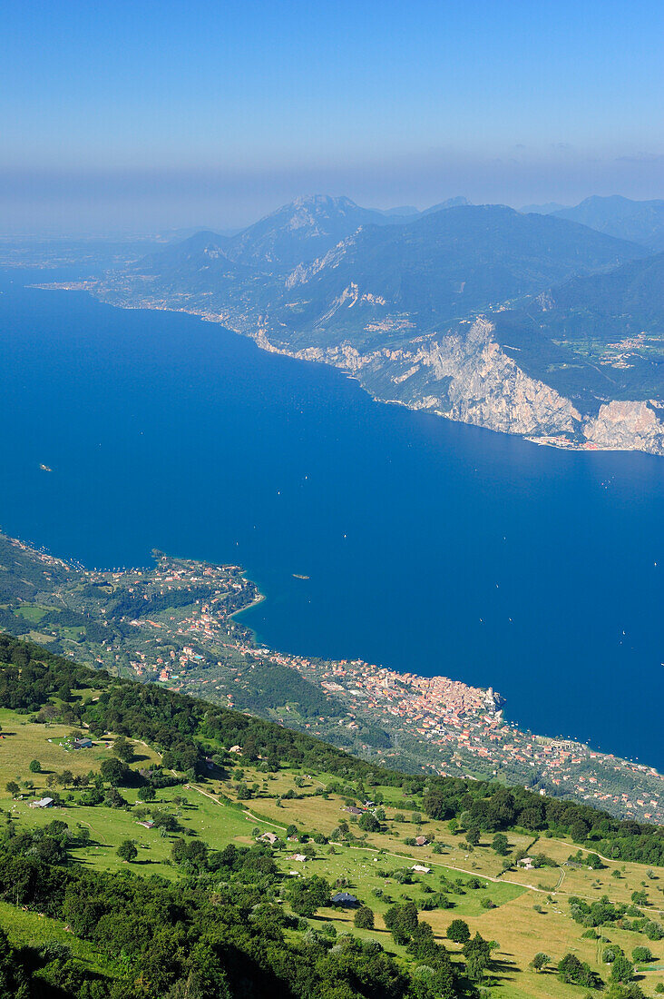 View over lake Garda with Malcesine and mountain range of Lake Garda, Monte Baldo, Trentino-Alto Adige/Suedtirol, Italy