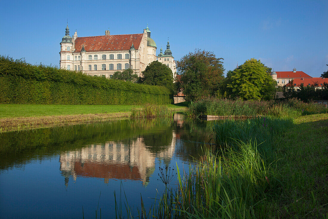 Reflection of Renaissance castle in a canal, Guestrow, Mecklenburg switzerland, Mecklenburg Western-Pomerania, Germany, Europe