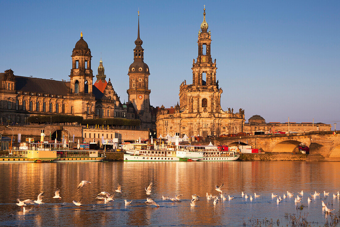 View over the Elbe river to Bruehlsche Terrasse, Staendehaus, Dresden castle and church Hofkirche in the evening light, Dresden, Saxonia, Germany