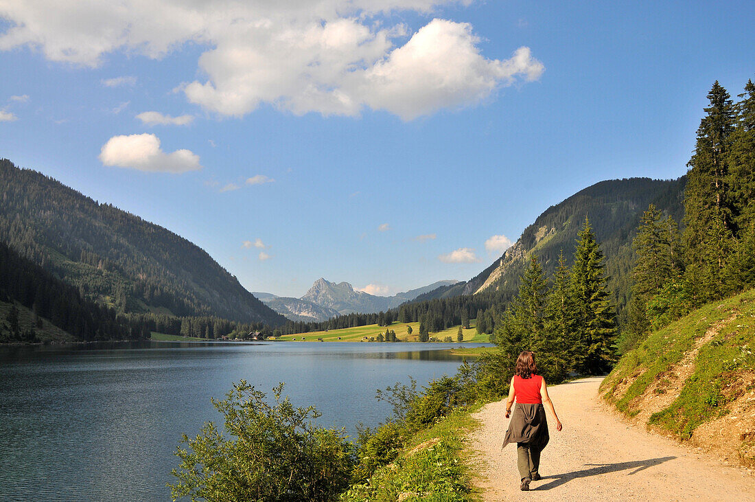 Hiker at lake Vilsalp in the Tannheim valley, Ausserfern, Tyrol, Austria, Europe