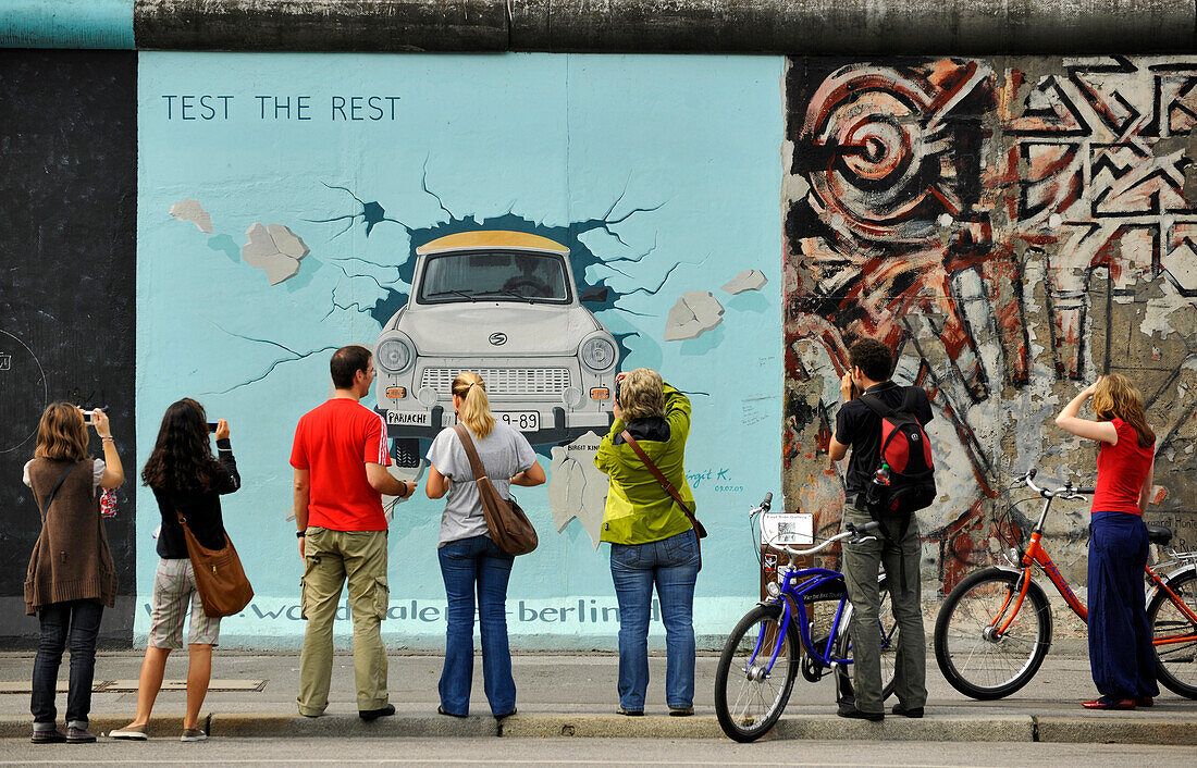 People in front of paintings of the East Side Gallery, Berliner Mauer, Muehlenstrasse, Berlin, Germany, Europe