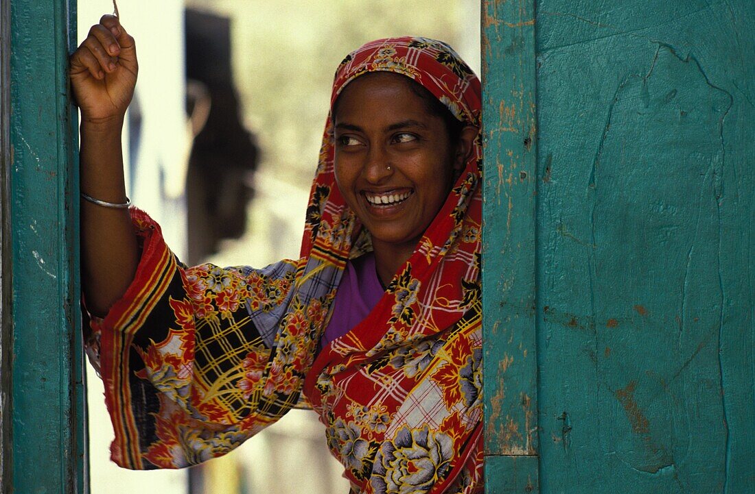 Bangladesh, Chittagong, Woman on her doorstep