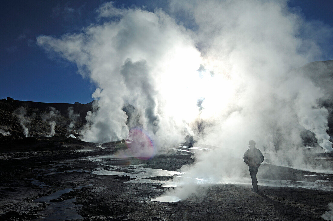 Chile, San Pedro de Atacama, El Tatio, person near geyser and steam