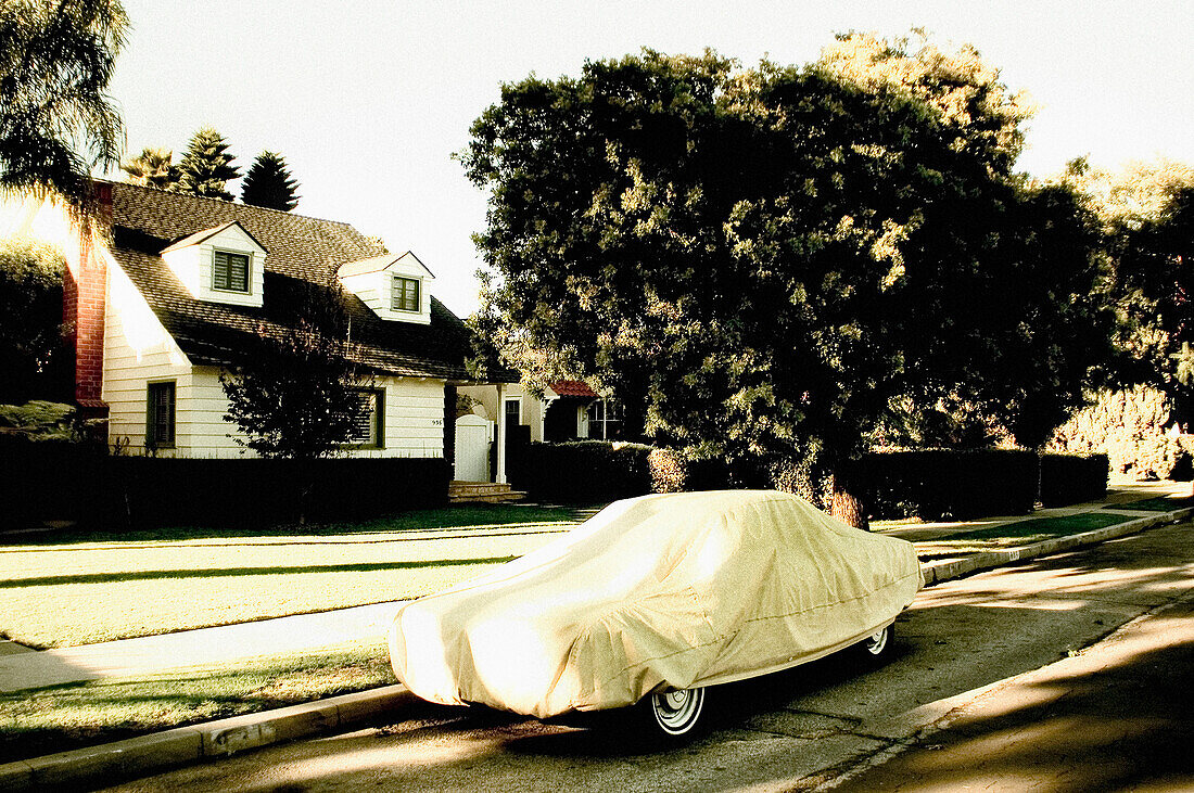 Car Covered With Tarpaulin in Front of Suburban Home, Venice, California, USA