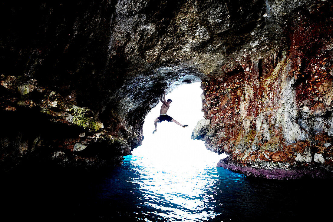 Male Rock Climber in Sea Cave, Mallorca, Spain