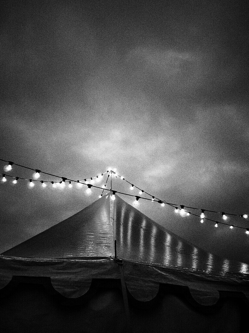 Circus Tent and String of Lights Against Dramatic Sky