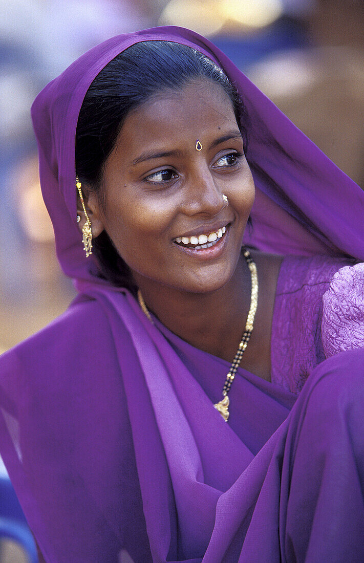 Indian woman wearing purple Sari. Goa, India.