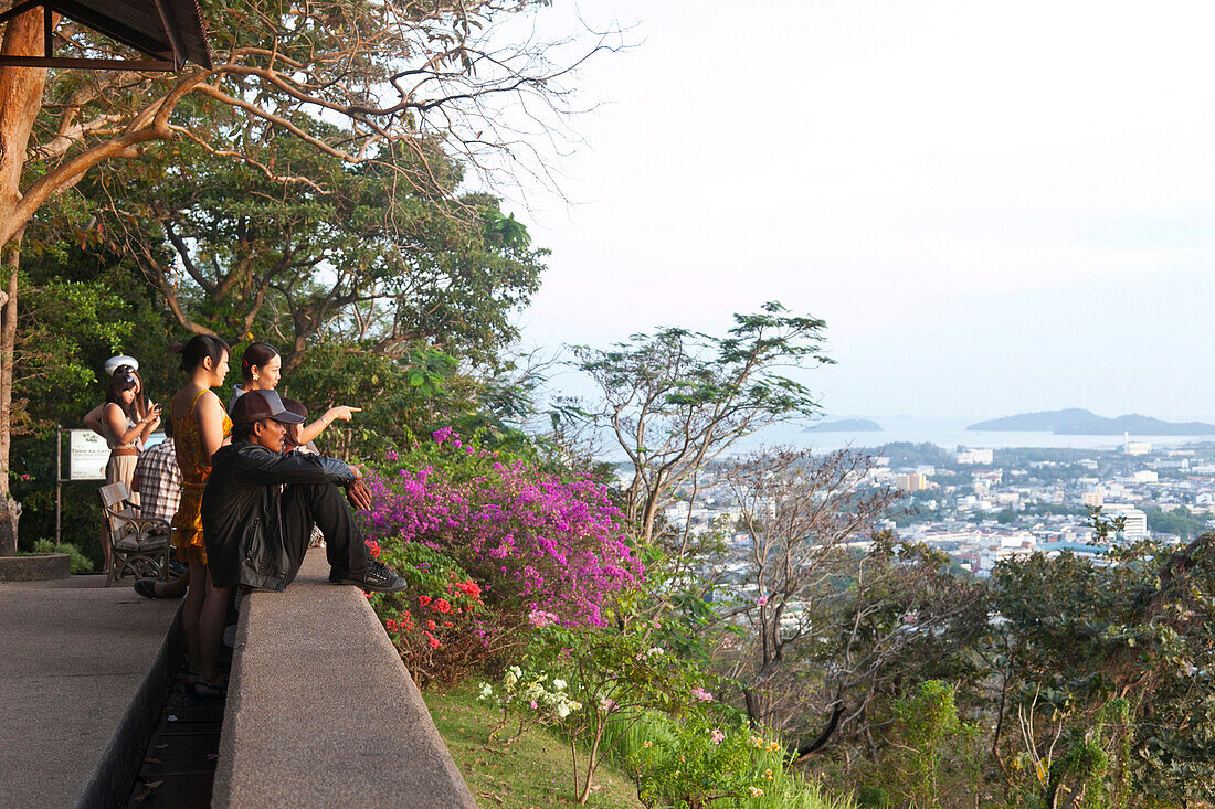 Thai people enjoying the view from Rong Hill over the city at sunset, Phuket, Thailand, Asia