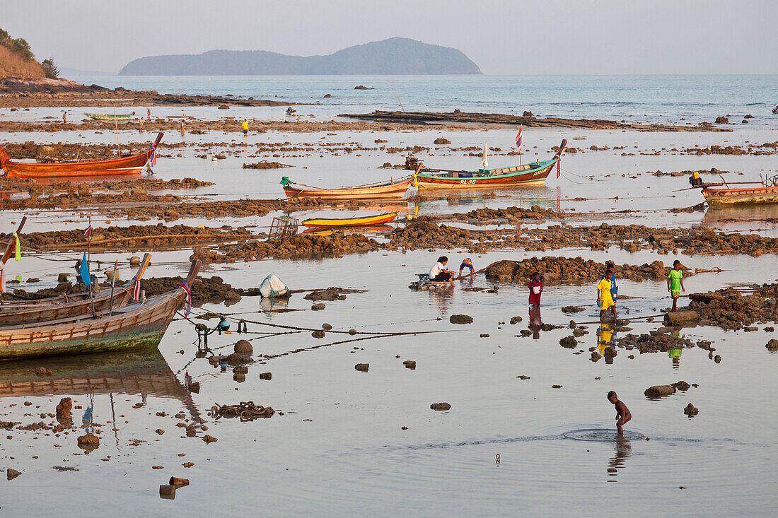 Children playing in the shallow water at low tide, Rawai, Phuket, Thailand, Asia