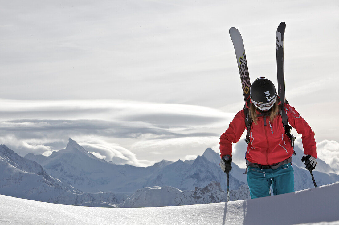 Female skier ascending through deep snow, Chandolin, Anniviers, Valais, Switzerland