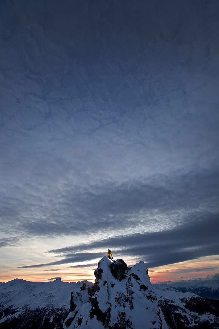 Snowboarder standing on a mountain in twilight, Chandolin, Anniviers, Valais, Switzerland