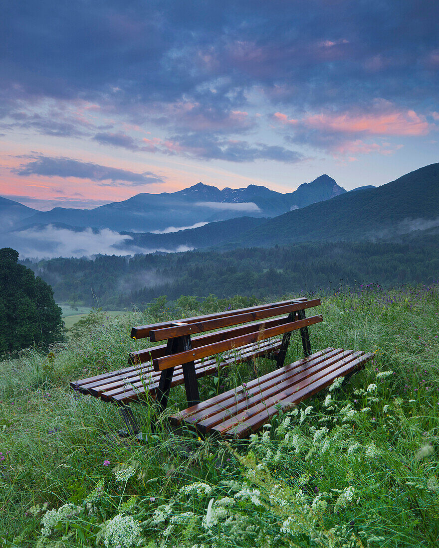 Bench in the middle of a field, Ampezzo, Friuli, Italy