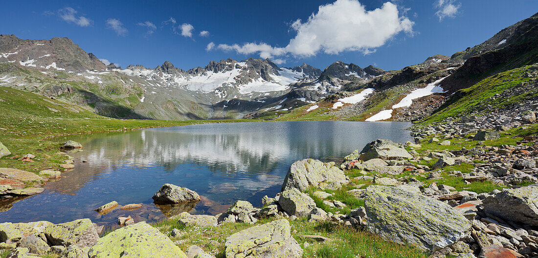 Reflection of mountains in Lake Radsee, Totenfeldkopf mountain in the background, Bieltal, Tyrol, Austria