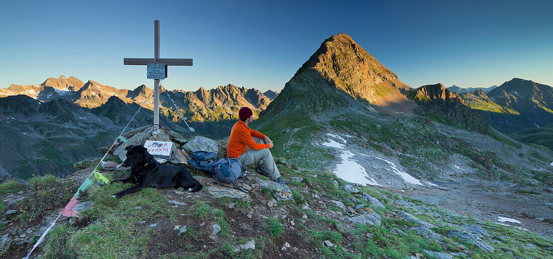 A person with a dog at the summit of a mountain, Hohes Rad, Radsattel, Bieltal, Vorarlberg, Tyrol, Austria