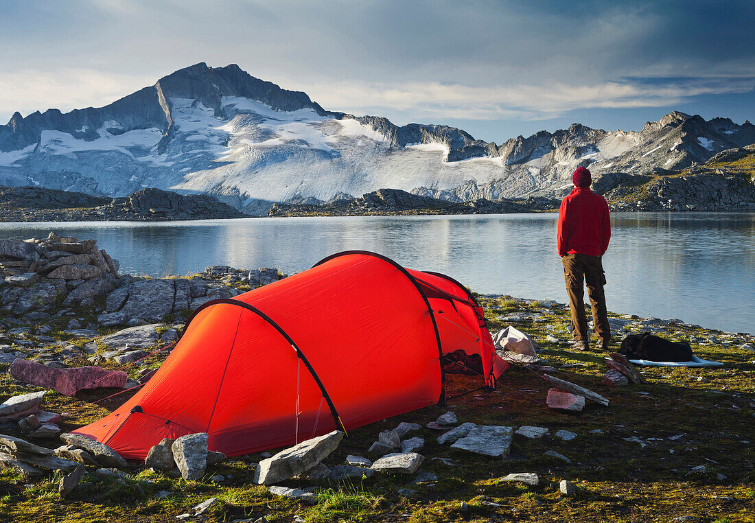 Person with tent in front of lake Schwarzhornsee and Hochalmspitze, Hohe Tauern National Park, Carinthia, Austria, Europe