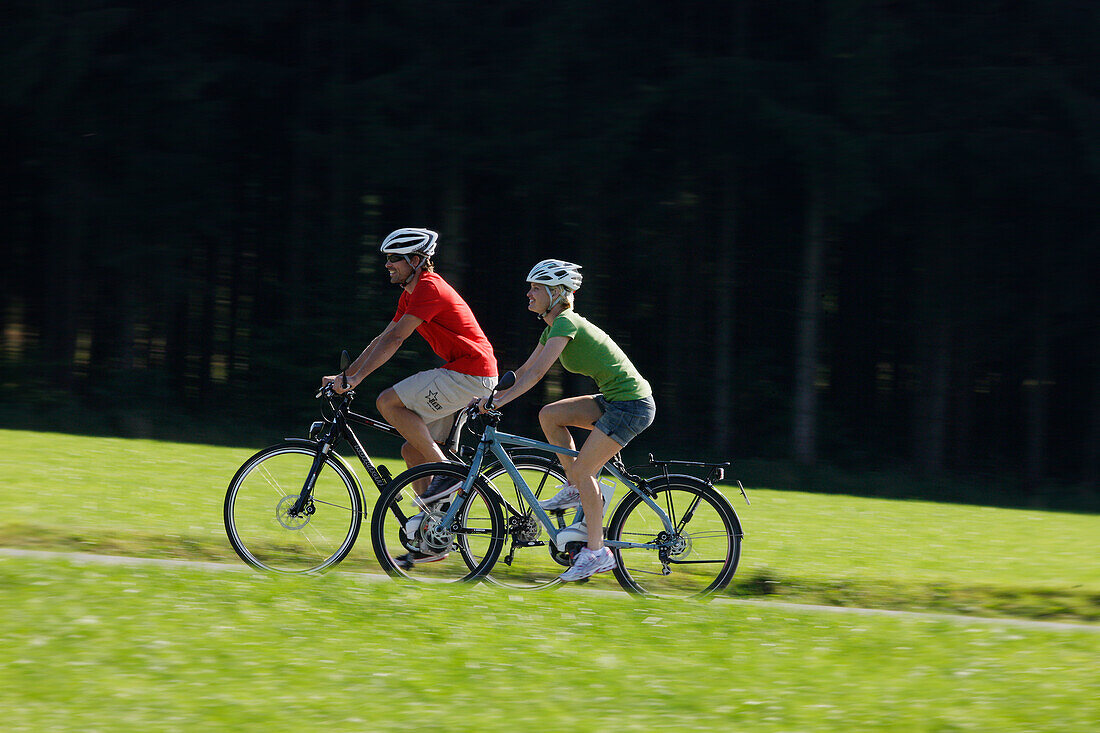 Cyclists riding e-bikes, Lake Starnberg, Bavaria, Germany