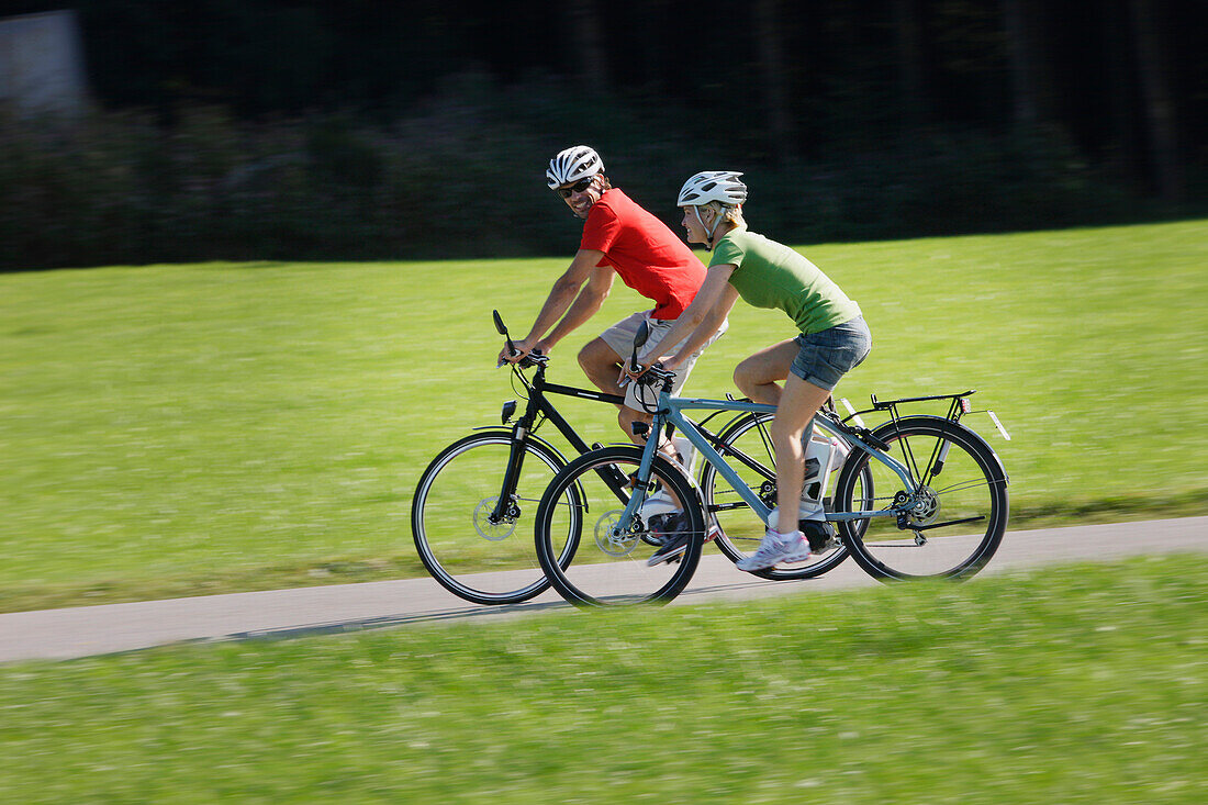 Cyclists riding e-bikes, Lake Starnberg, Bavaria, Germany