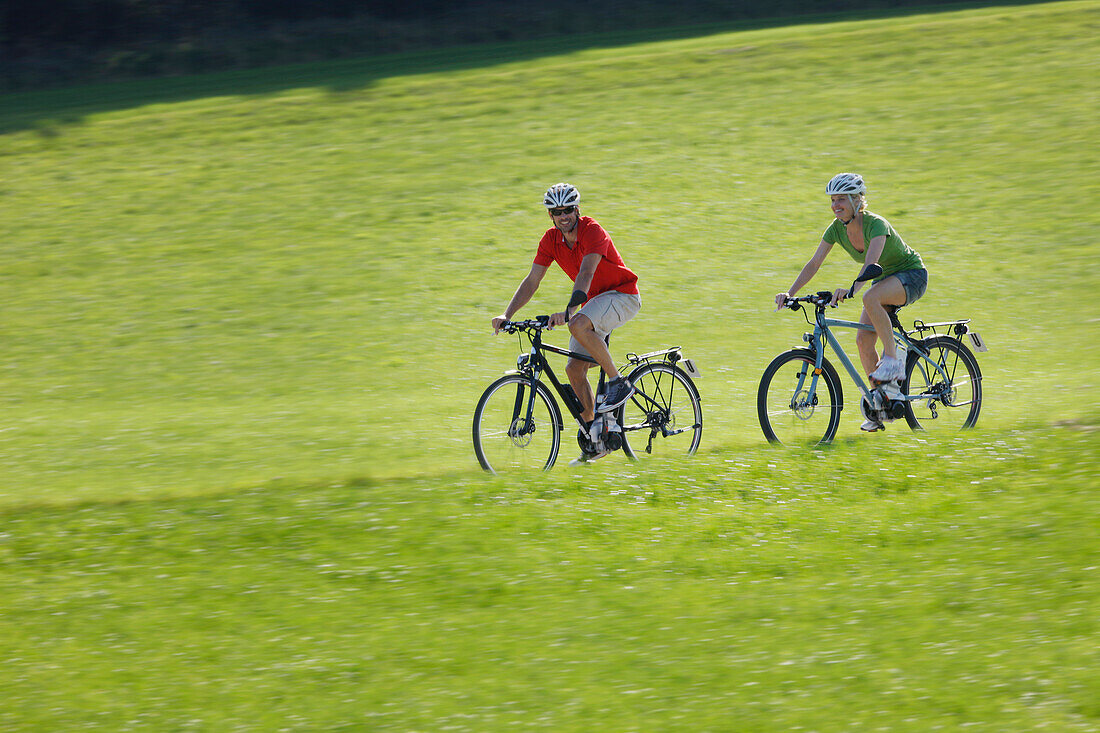 Cyclists riding e-bikes, Lake Starnberg, Bavaria, Germany