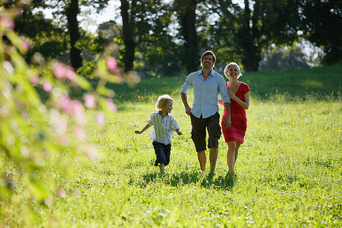 Family walking on meadow, Lake Starnberg, Bavaria, Germany