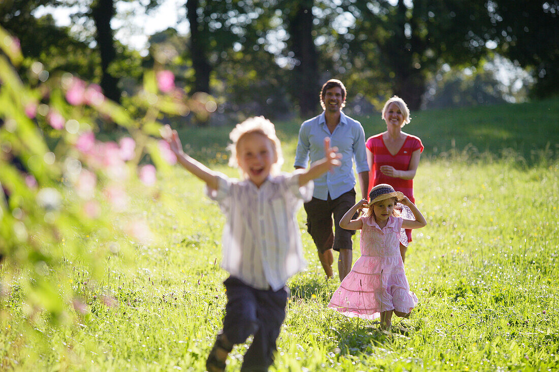 Family walking over meadow, Lake Starnberg, Bavaria, Germany