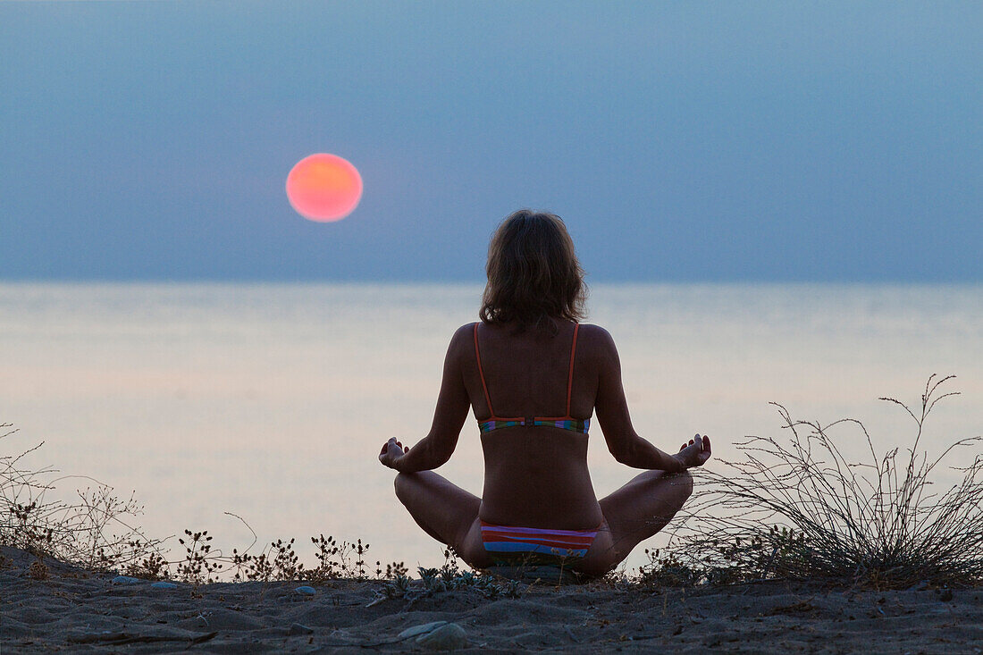 Woman practising Yoga at sunrise, Mediterranean Sea, Lykia, Turkey, Europe