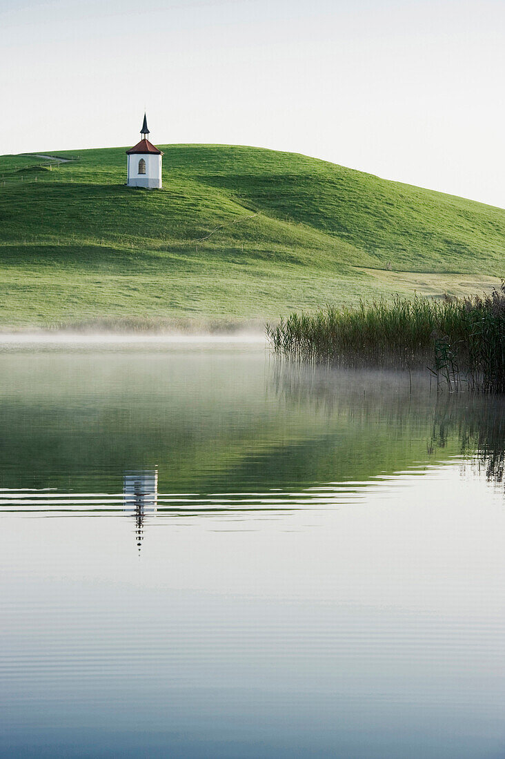 View over lake Hegratsried to chapel royal, Halblech, Allgaeu, Bavaria, Germany