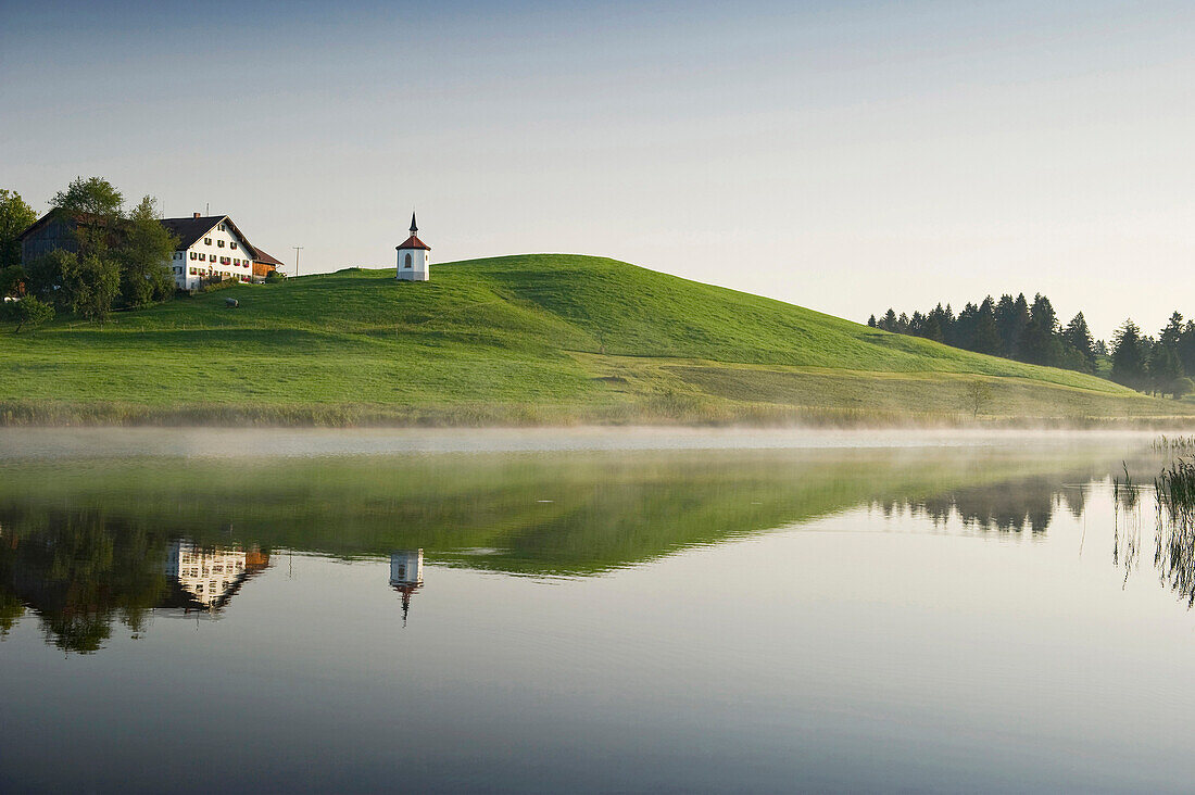 View over lake Hegratsried to chapel royal, Halblech, Allgaeu, Bavaria, Germany