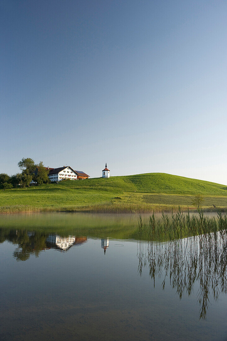 View over lake Hegratsried to chapel royal, Halblech, Allgaeu, Bavaria, Germany