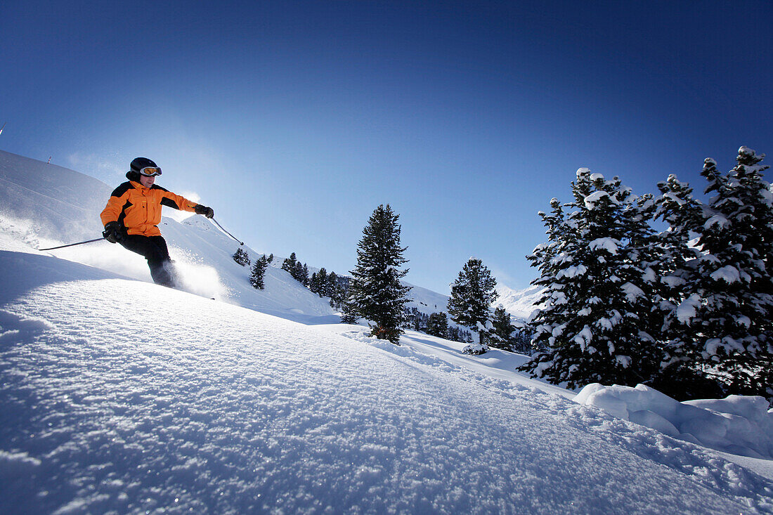 Skier sking down fresh new snow at Hohen Mut, Obergurgl, Tyrol, Austria