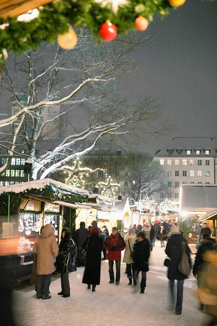 Christkindlmarkt, Christmas market on Rathausplatz square in the evening, Munich, Bavaria, Germany