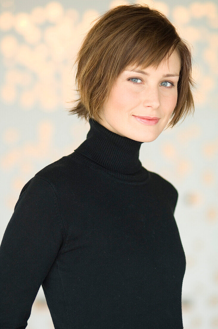 Portrait of a young woman with black sweater, looking at the camera