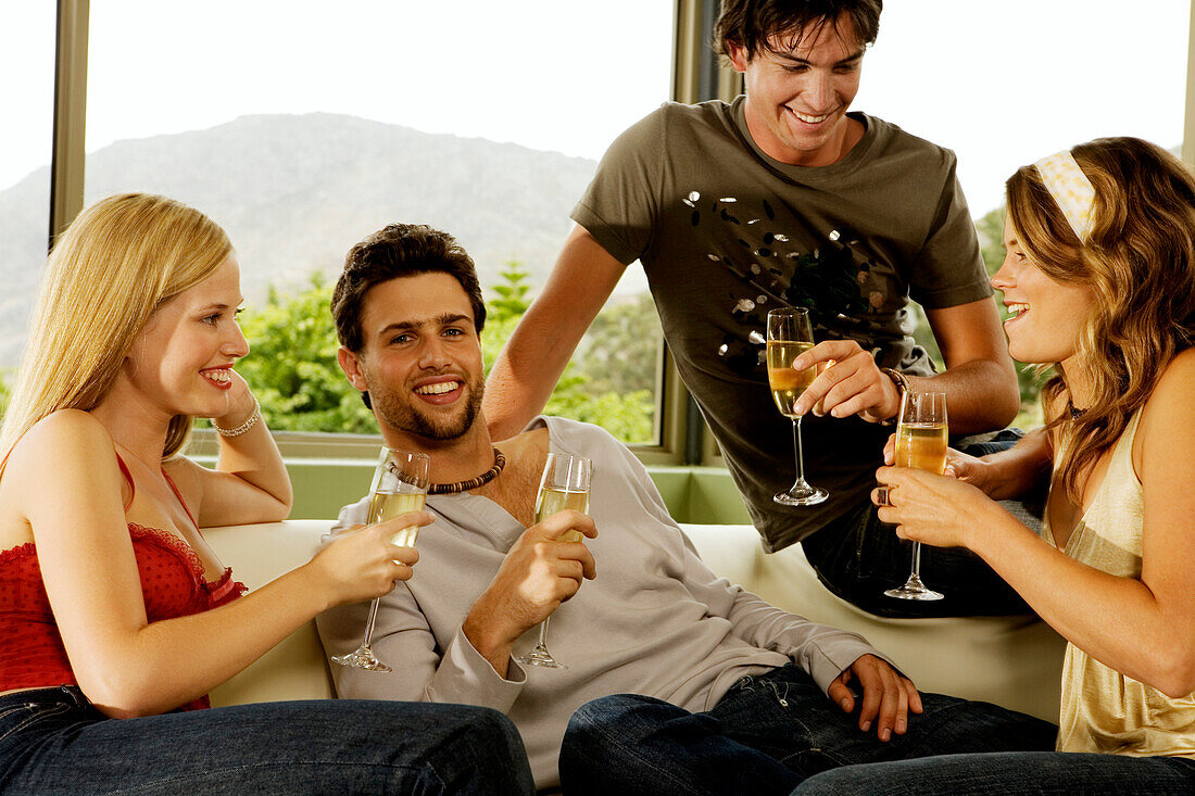 2 young couples drinking champagne
