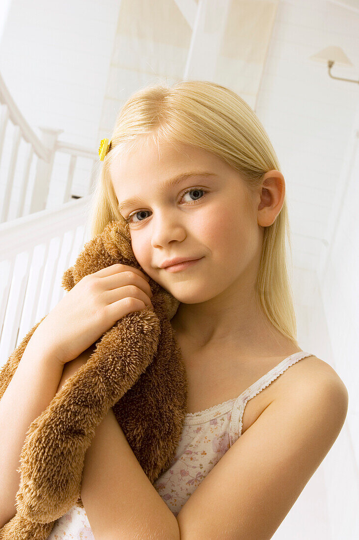 Portrait of a girl holding a teddy bear