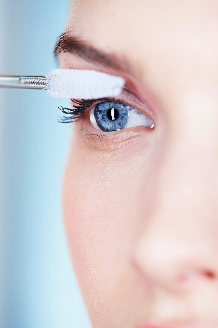 Woman applying mascara