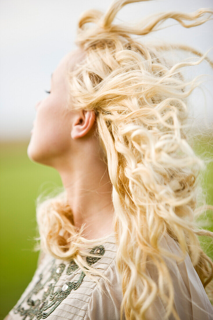 Portrait of a young woman, hair in the wind