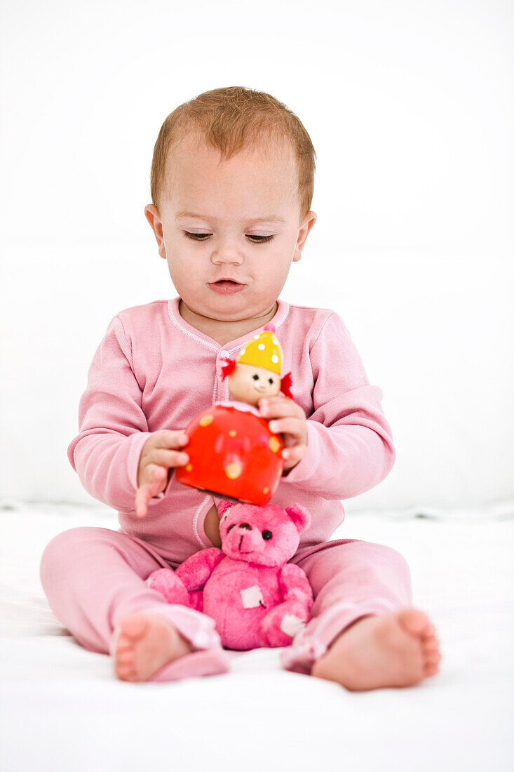 Baby girl playing with toys