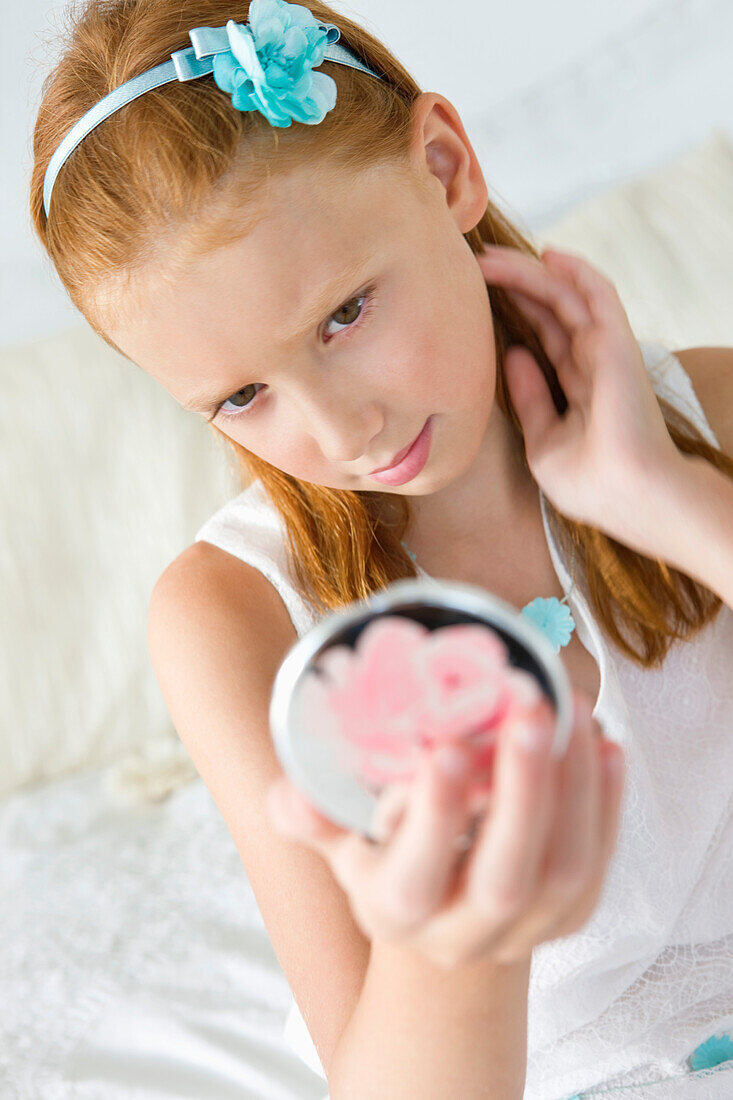 Girl holding a hand mirror