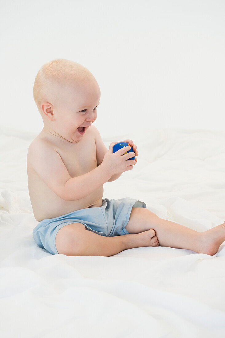 Baby boy playing with a ball