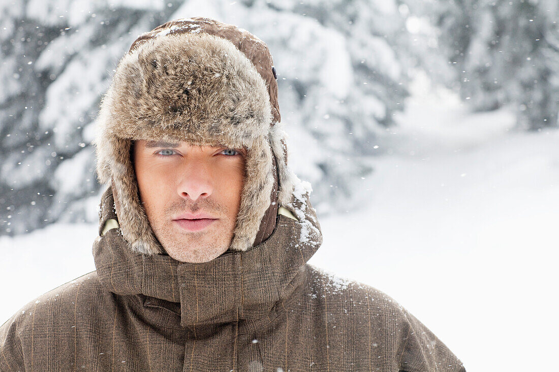 Young man in winter clothes looking at camera