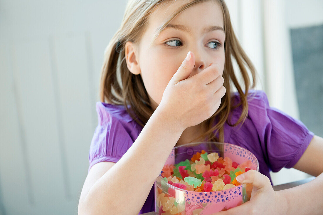 Girl holding a box full of gum drops