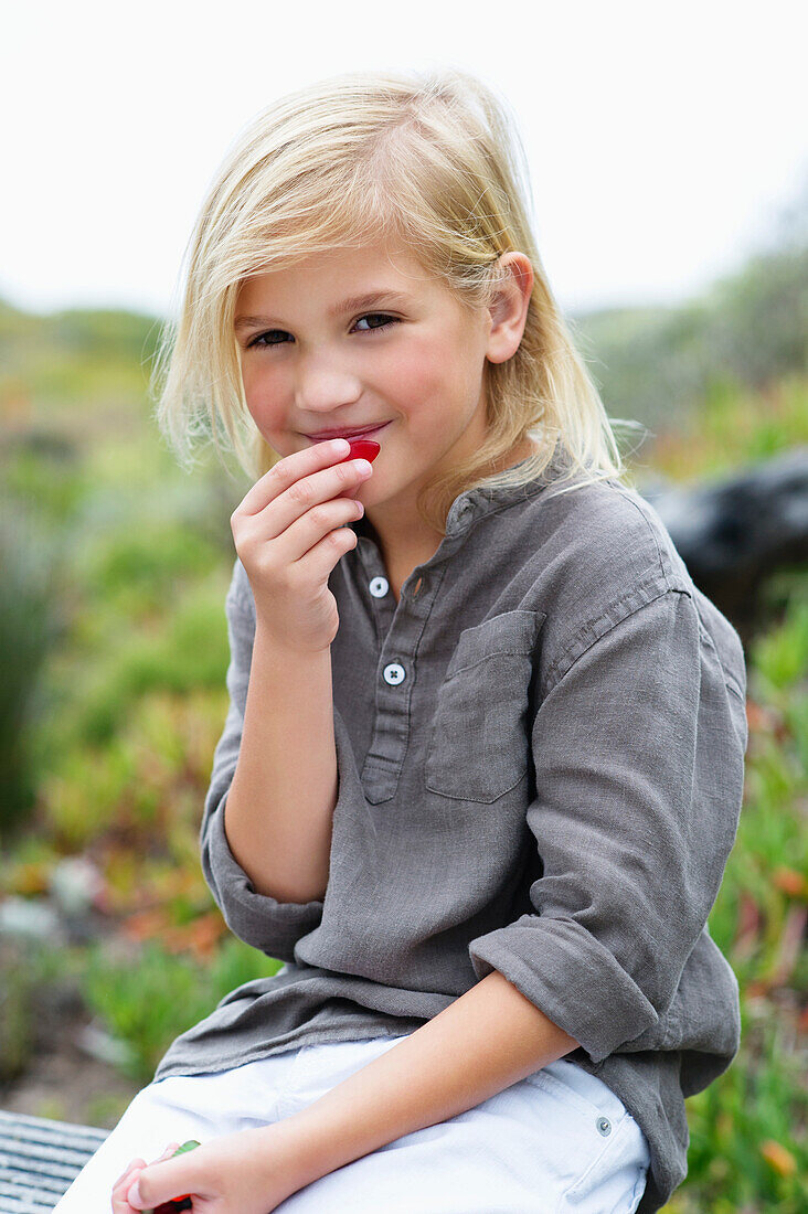 Portrait of a girl eating fruit