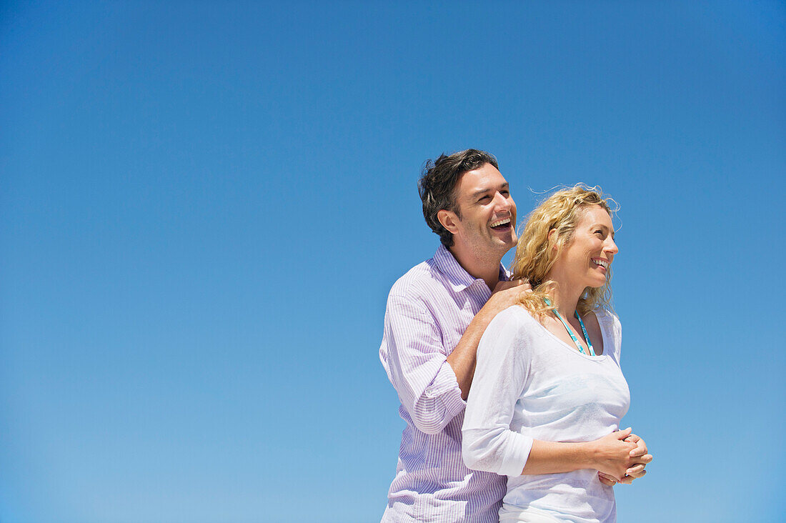 Side profile of a couple smiling