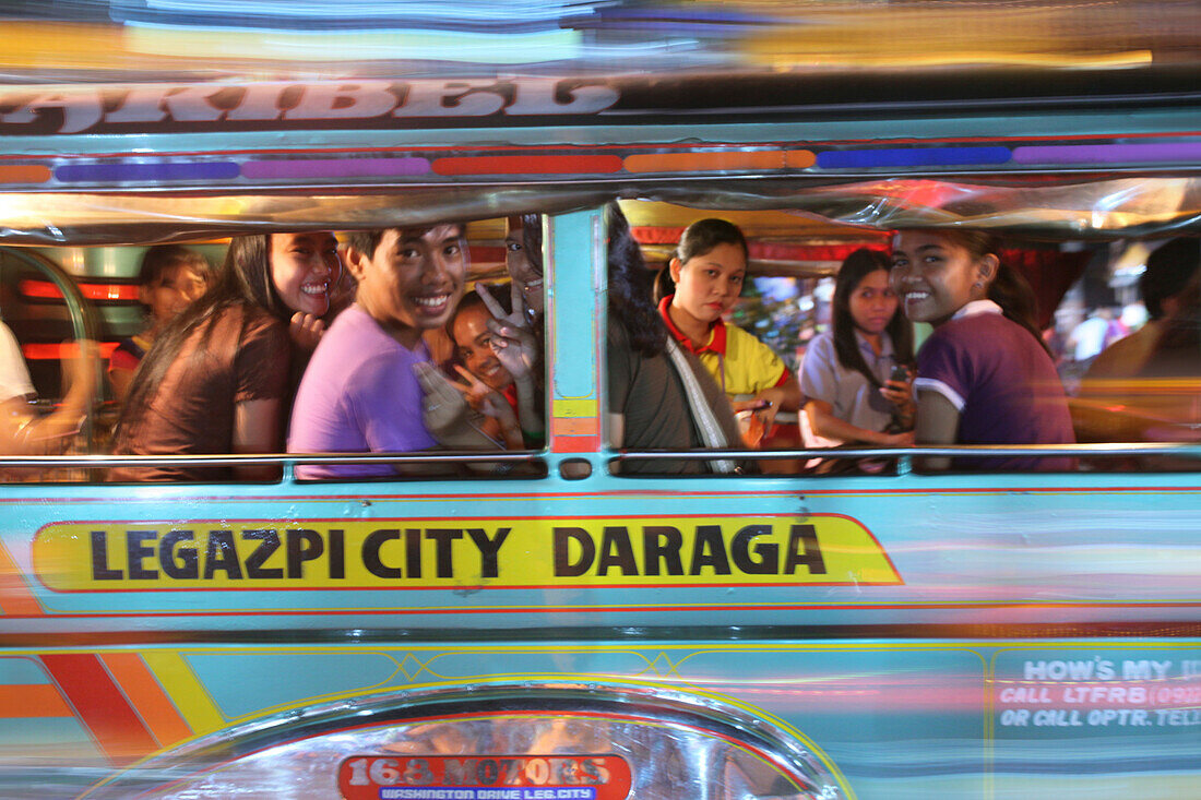 Smiling young people in a jeepney, Legazpi City, Luzon Island, Philippines, Asia