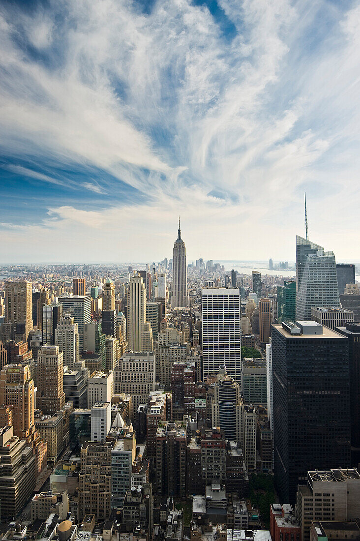 Empire State Building and Rockefeller Center under clouded sky, Manhattan, New York, USA, America
