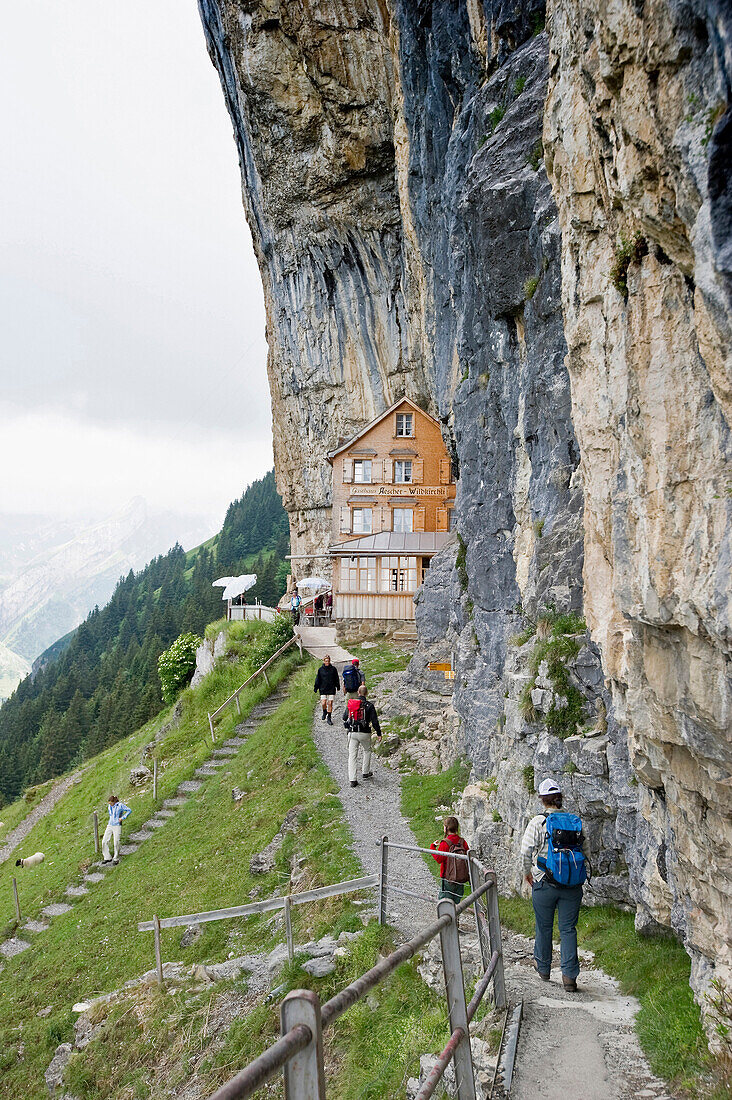 Mountain hikers near mountain inn Aescher, Ebenalp, Alpstein massif, Appenzell Innerrhoden, Switzerland